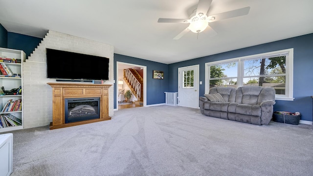 1008 Mary Ave, Dixon, IL 61021 - living room featuring carpet, ceiling fan, baseboards, and a fireplace