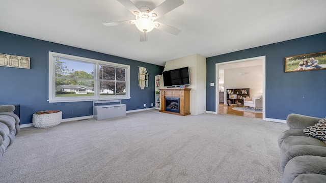 1008 Mary Ave, Dixon, IL 61021 - carpeted living area with a ceiling fan, a fireplace, and baseboards