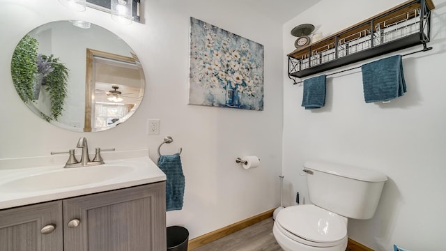 1008 Mary Ave, Dixon, IL 61021 - bathroom with toilet, wood finished floors, baseboards, vanity, and ceiling fan