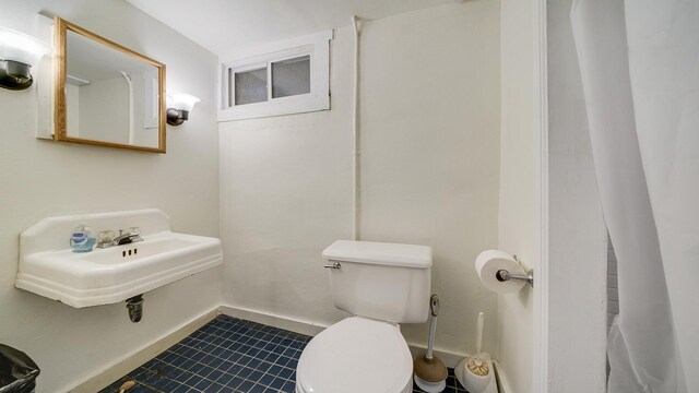 1008 Mary Ave, Dixon, IL 61021 - bathroom with toilet, baseboards, tile patterned floors, and a sink
