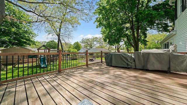 1008 Mary Ave, Dixon, IL 61021 - wooden deck featuring a playground, a grill, and an outdoor structure