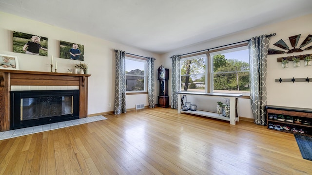 1008 Mary Ave, Dixon, IL 61021 - unfurnished living room with a tile fireplace, hardwood / wood-style floors, and baseboards