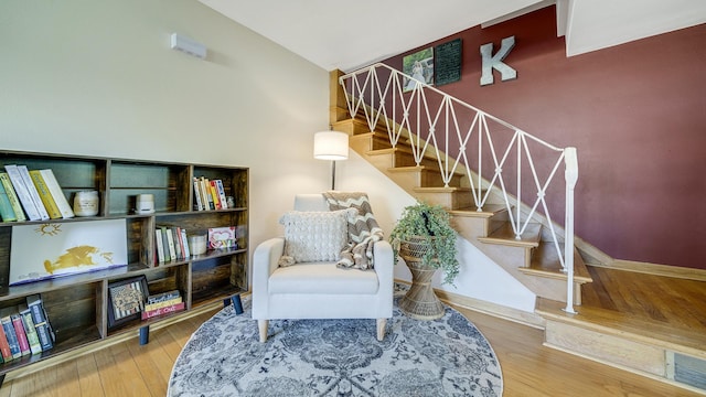 1008 Mary Ave, Dixon, IL 61021 - living area featuring wood finished floors, stairs, baseboards, and vaulted ceiling