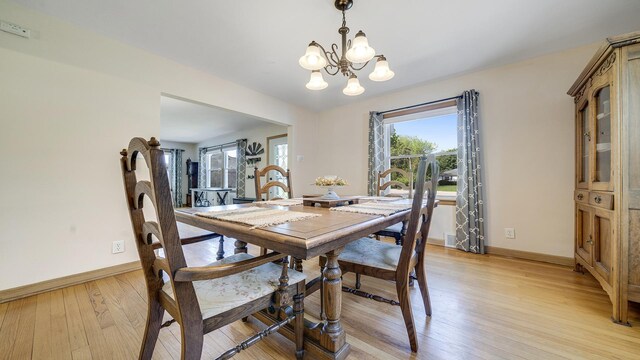 1008 Mary Ave, Dixon, IL 61021 - dining area with a chandelier, baseboards, and light wood-style flooring