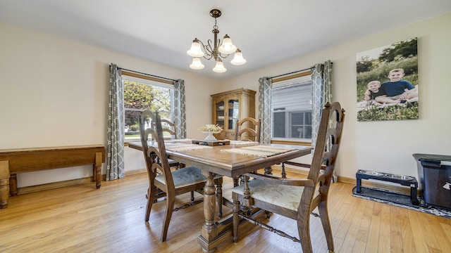 1008 Mary Ave, Dixon, IL 61021 - dining space featuring a chandelier, light wood finished floors, and baseboards