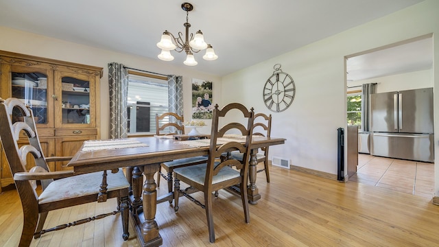 1008 Mary Ave, Dixon, IL 61021 - dining area with a chandelier, light wood finished floors, and baseboards