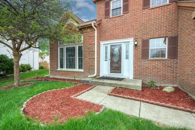 3615 Fairfax Ct E, Aurora, IL 60504 - view of exterior entry featuring brick siding and a lawn