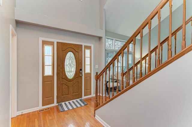3615 Fairfax Ct E, Aurora, IL 60504 - entryway featuring hardwood / wood-style floors, a high ceiling, baseboards, and stairway