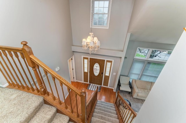 3615 Fairfax Ct E, Aurora, IL 60504 - foyer featuring a chandelier, a towering ceiling, wood finished floors, and stairs