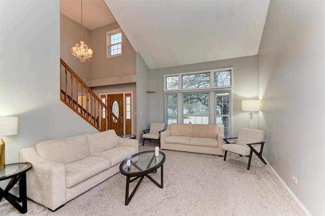 3615 Fairfax Ct E, Aurora, IL 60504 - living room with high vaulted ceiling, a chandelier, carpet floors, stairway, and baseboards