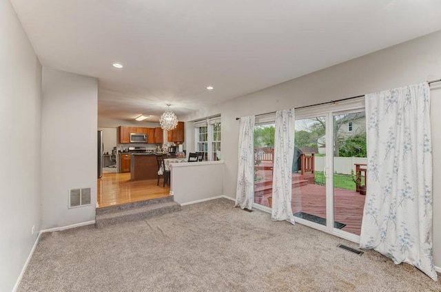 3615 Fairfax Ct E, Aurora, IL 60504 - living room featuring light carpet, a chandelier, baseboards, and recessed lighting