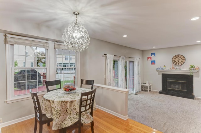 3615 Fairfax Ct E, Aurora, IL 60504 - dining area with recessed lighting, a chandelier, baseboards, a glass covered fireplace, and light wood-style floors