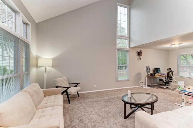 3615 Fairfax Ct E, Aurora, IL 60504 - carpeted living area with an office area, high vaulted ceiling, and baseboards