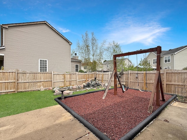 view of playground featuring a fenced backyard and a yard