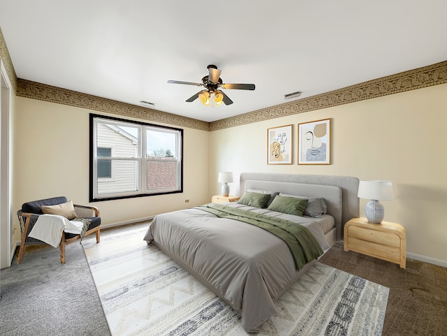 bedroom featuring baseboards, a ceiling fan, and visible vents