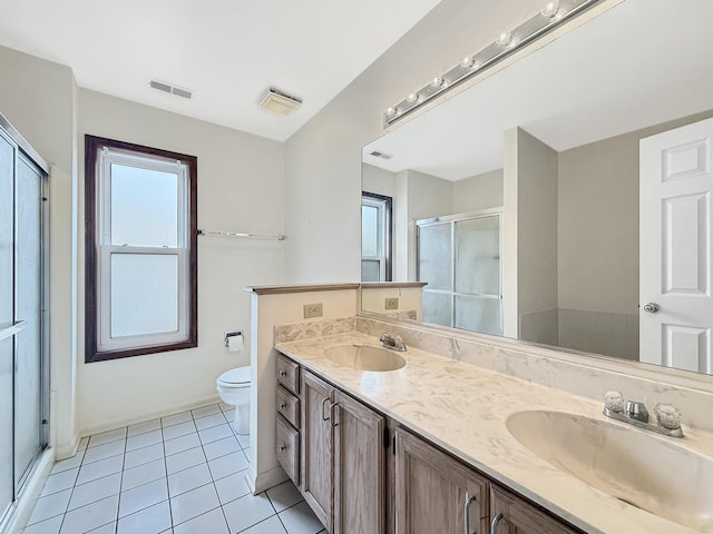 full bathroom featuring tile patterned floors, visible vents, a shower stall, and a sink