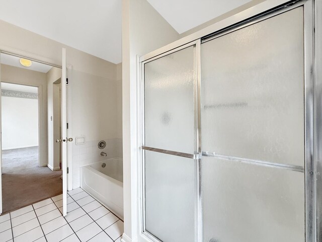 full bath featuring tile patterned floors, baseboards, a stall shower, and a garden tub