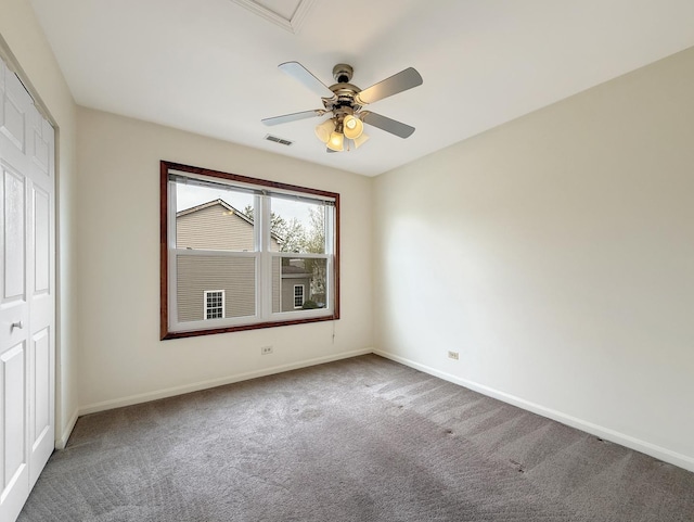 unfurnished bedroom featuring visible vents, a closet, baseboards, ceiling fan, and carpet flooring