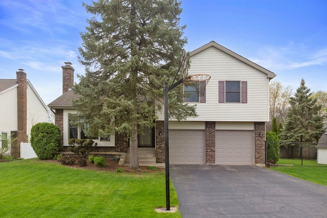 759 Dunmore Ln, Bartlett, IL 60103 - split level home featuring fence, an attached garage, brick siding, driveway, and a front yard