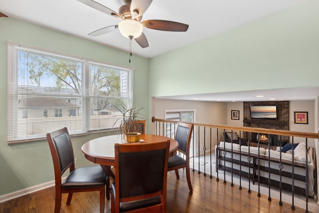 759 Dunmore Ln, Bartlett, IL 60103 - dining room featuring a ceiling fan, a brick fireplace, baseboards, and wood finished floors