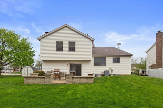759 Dunmore Ln, Bartlett, IL 60103 - back of house with a storage unit, an outdoor structure, and a lawn