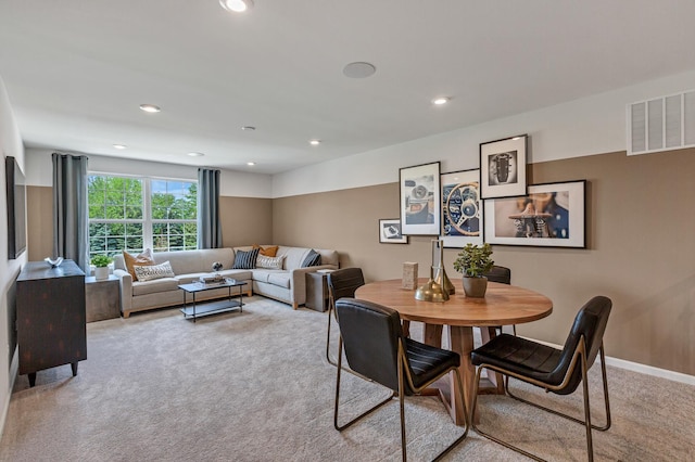 dining room featuring light carpet, recessed lighting, and visible vents