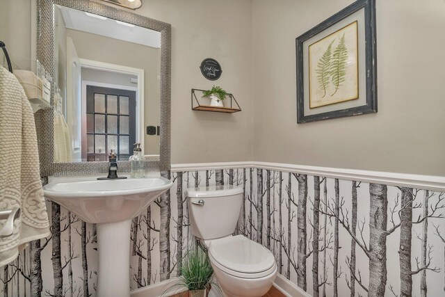 bathroom with toilet and wainscoting