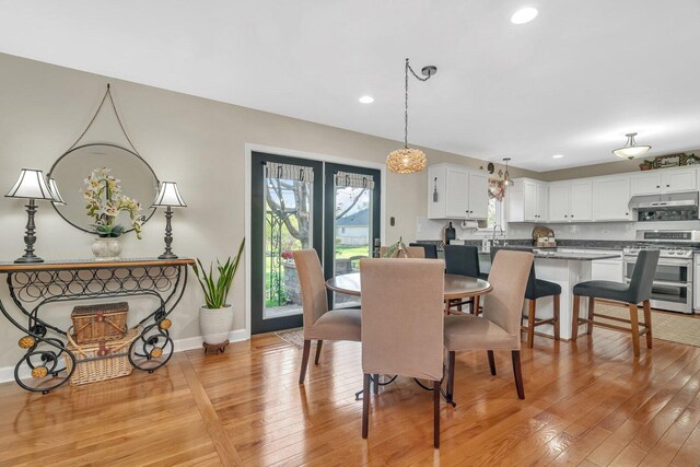 dining area with recessed lighting, baseboards, and light wood-style flooring