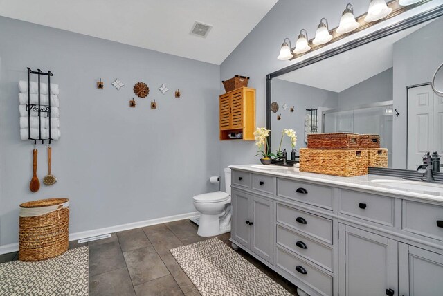 full bath featuring visible vents, a sink, a stall shower, and vaulted ceiling