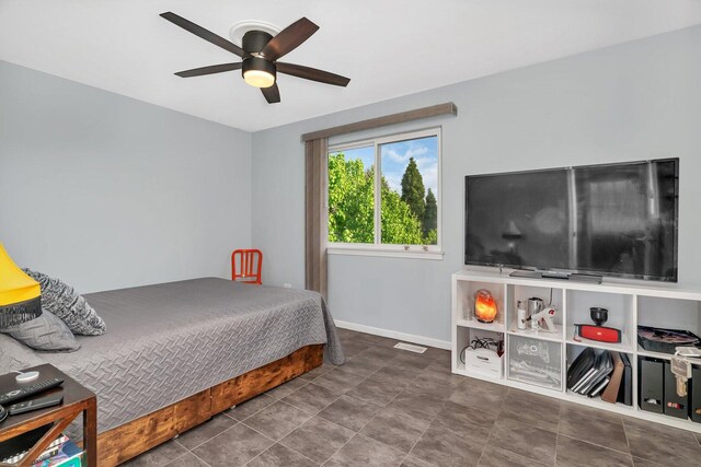 tiled bedroom with visible vents, baseboards, and ceiling fan
