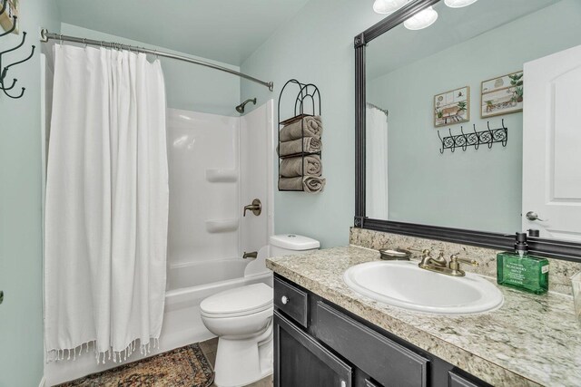 full bath with vanity, shower / bath combination with curtain, and toilet