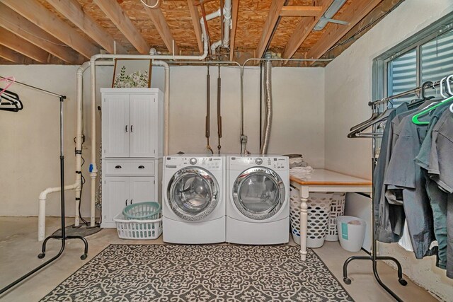 clothes washing area with washing machine and clothes dryer