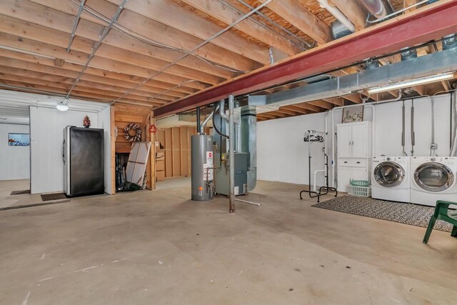 unfinished basement featuring water heater, heating unit, and washing machine and dryer