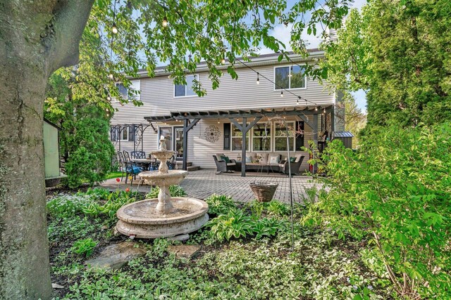 rear view of property with an outdoor hangout area, a pergola, and a patio area