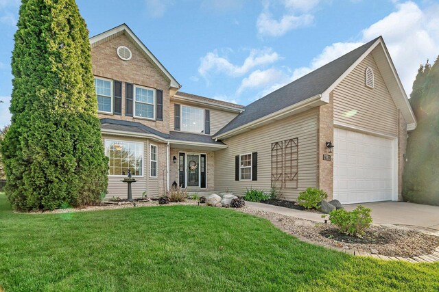 traditional-style home with a shingled roof, brick siding, a garage, a front yard, and driveway