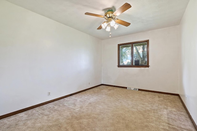 empty room featuring baseboards, carpet flooring, and visible vents