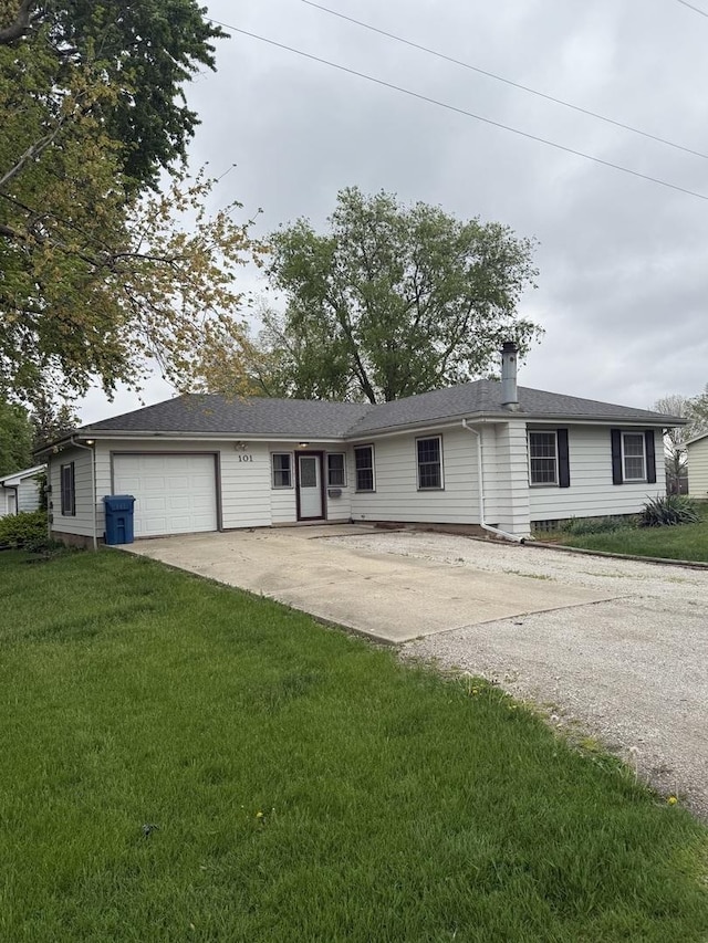ranch-style house with an attached garage, driveway, a chimney, and a front yard