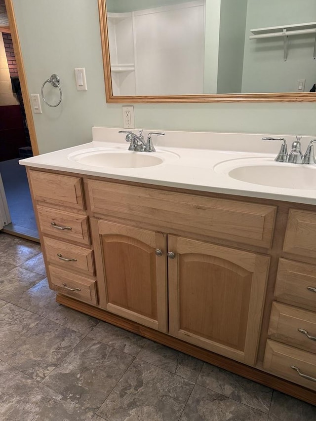 full bath with a sink and double vanity