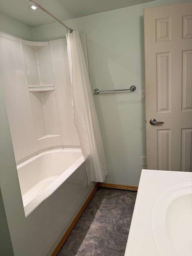 bathroom featuring a sink, baseboards, recessed lighting, and shower / tub combo with curtain