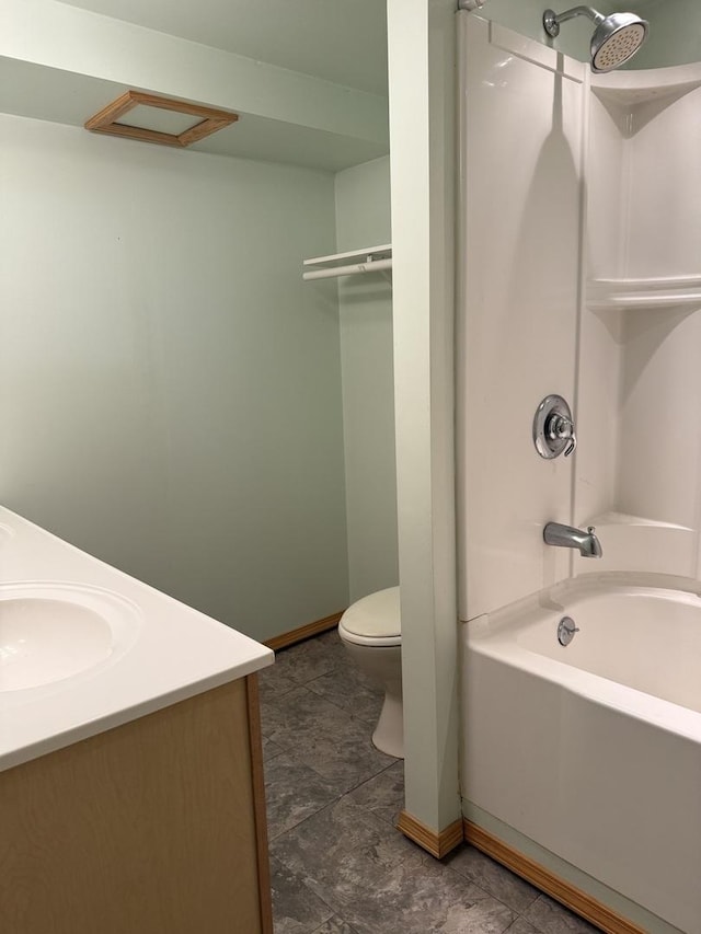 bathroom featuring toilet, baseboards, and vanity