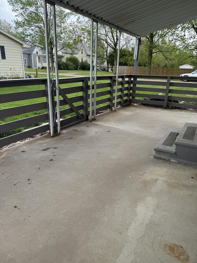 view of patio featuring fence and a residential view