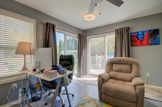 office area featuring wood finished floors, ceiling fan, and baseboards