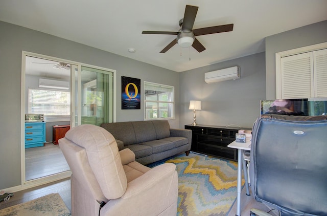 living room featuring a wall mounted AC, ceiling fan, and plenty of natural light