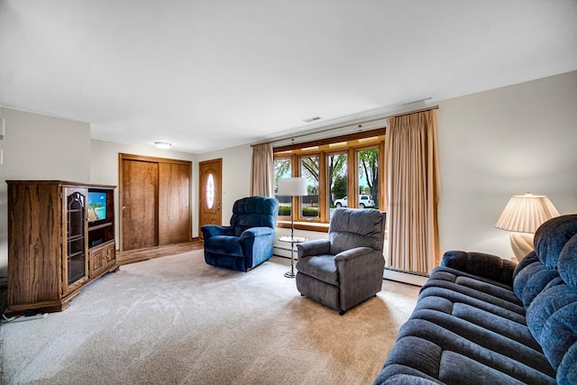living area with light colored carpet, a baseboard radiator, a baseboard heating unit, and visible vents