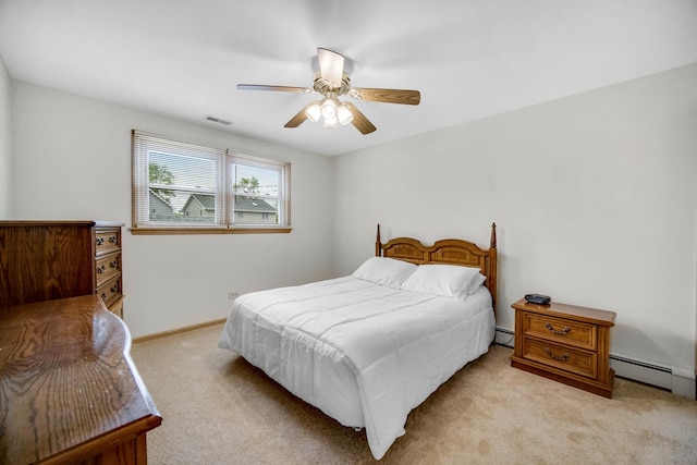 bedroom featuring ceiling fan, visible vents, light colored carpet, baseboards, and a baseboard heating unit