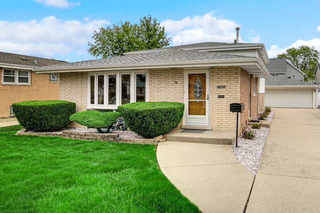 ranch-style house with brick siding, roof with shingles, an outbuilding, and a front yard