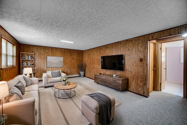living room featuring wooden walls, a baseboard heating unit, and carpet