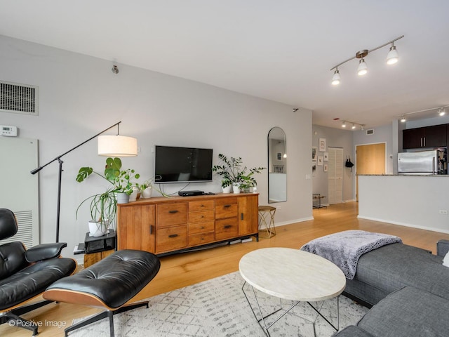 123 S Green St Unit 710B, Chicago, IL 60607 - living room with visible vents, baseboards, and light wood-type flooring