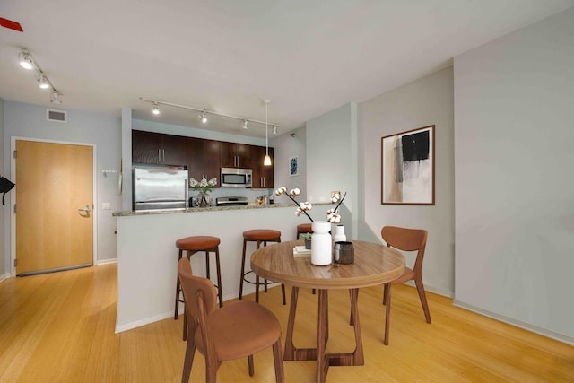 123 S Green St Unit 710B, Chicago, IL 60607 - dining room featuring visible vents, light wood-style floors, baseboards, and track lighting