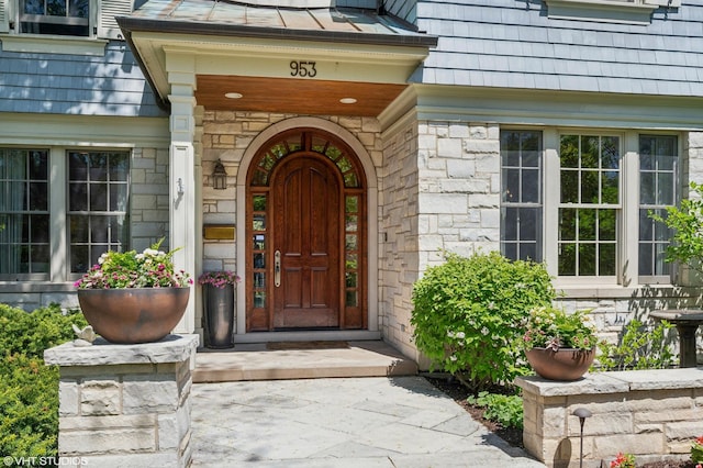 view of exterior entry featuring stone siding